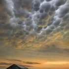 Unidentified flying objects over desert pyramid under dramatic sky