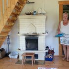 Rustic room with fireplace, vintage rocking chair, painter's ladder, and bohemian rug