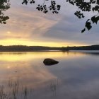 Tranquil lake sunrise with hot air balloon reflections