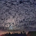 Surreal floating landmasses above Egyptian pyramids under starry sky