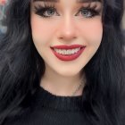 Smiling young woman portrait with freckles and dark hair