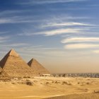 Desert landscape with Great Pyramids, elephant, people, and futuristic vehicles