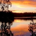 Scenic mountain landscape at sunset with radiant clouds reflecting in tranquil lake