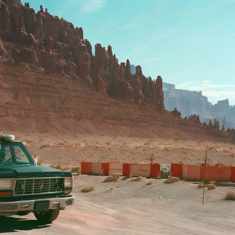 Vintage Truck Parked on Desert Road with Red Rock Formations