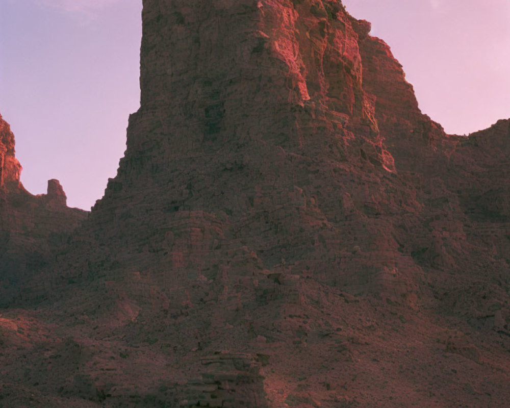 Rugged Rock Formation Under Soft Pink Sky