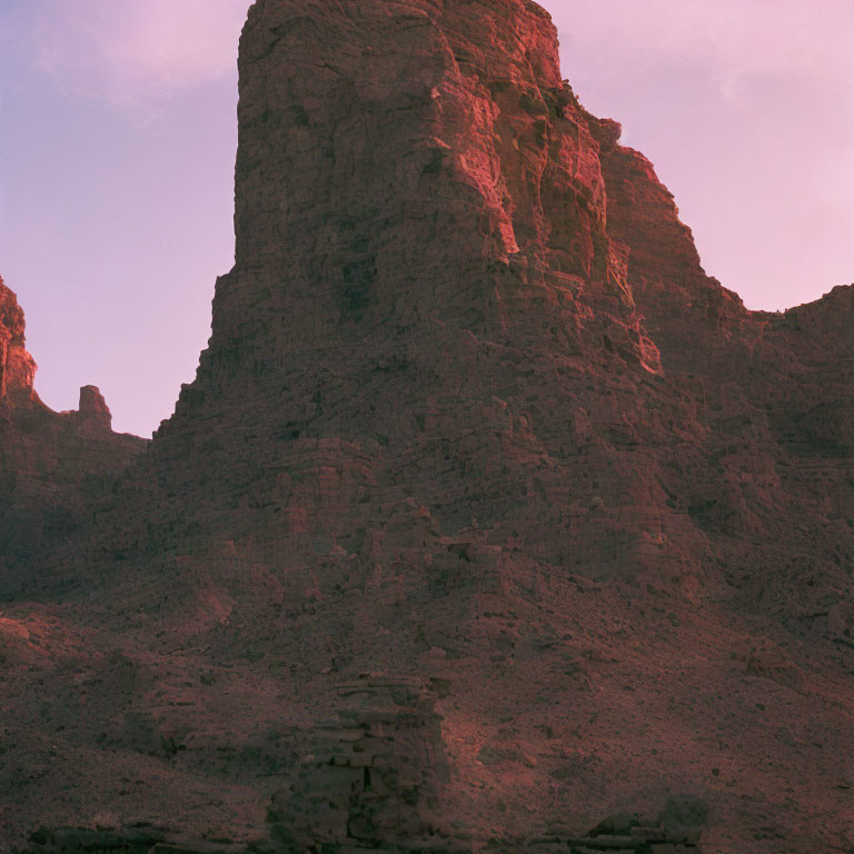 Rugged Rock Formation Under Soft Pink Sky