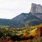 Vibrant autumn landscape with towering rock formation at sunrise