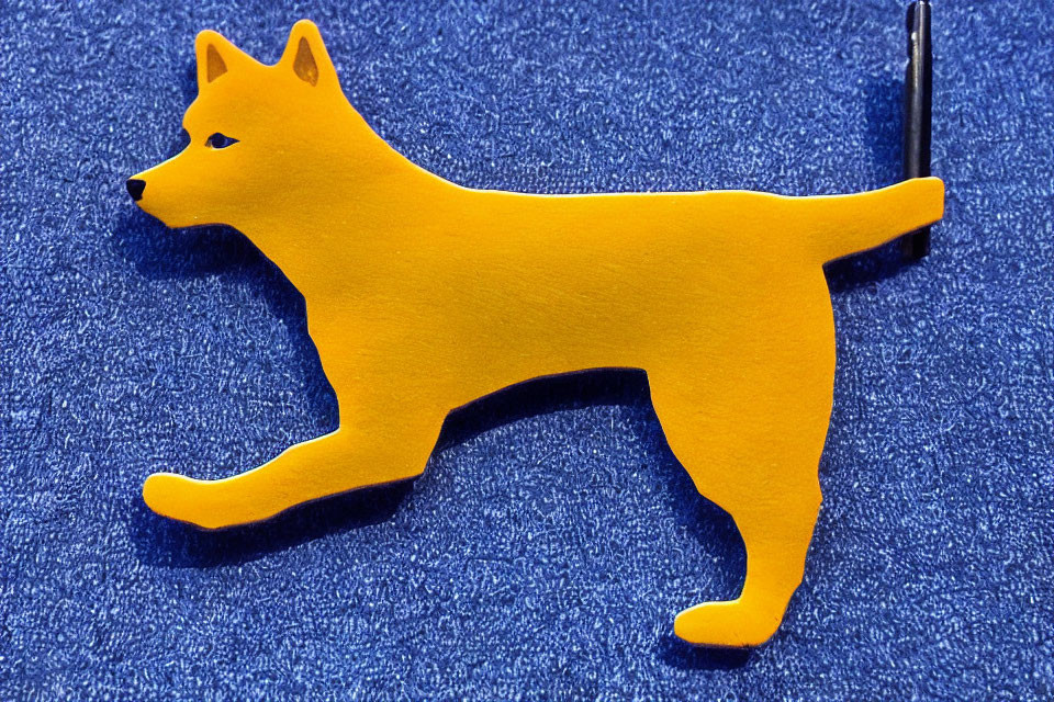 Yellow Dog Silhouette with Pen on Blue Textured Background