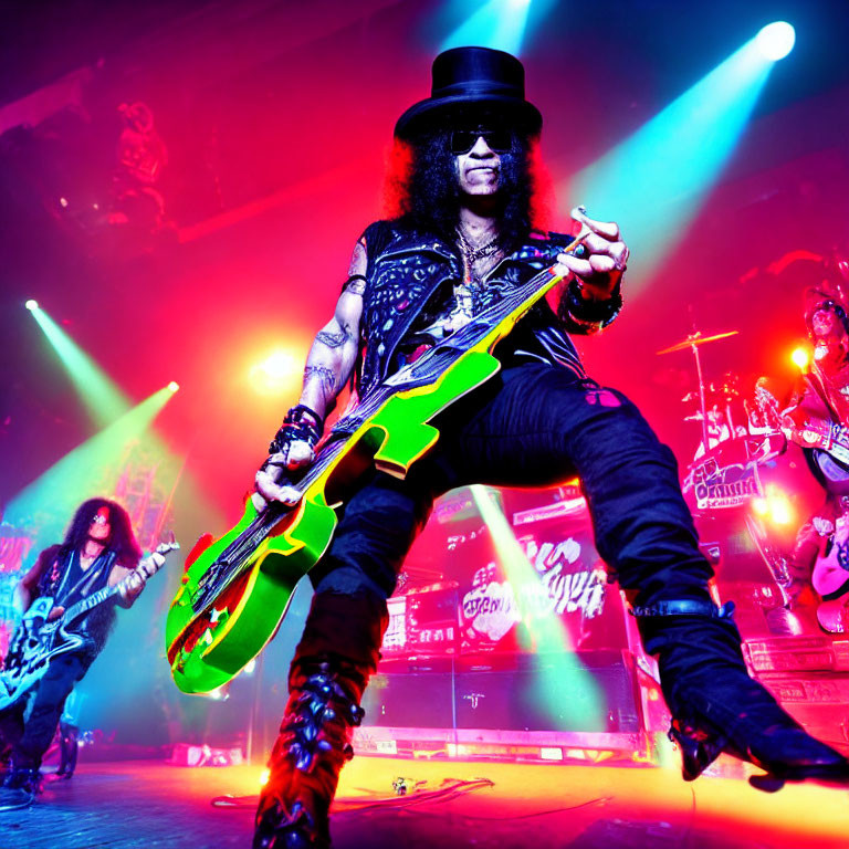 Rock guitarist in top hat plays neon green guitar on stage with vibrant lights