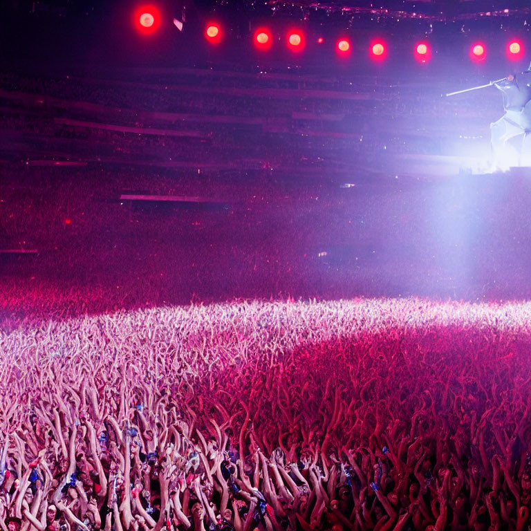 Vibrant Pink Concert Scene with Stage Lights and Raised Hands