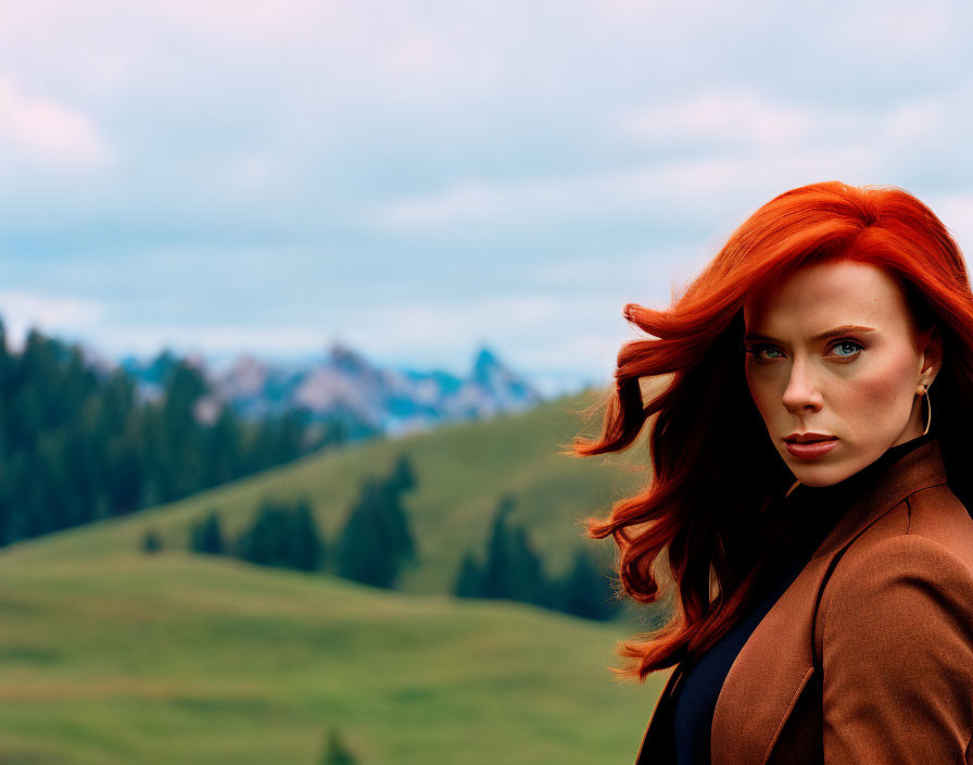 Red-haired woman in brown jacket against green hills and mountains