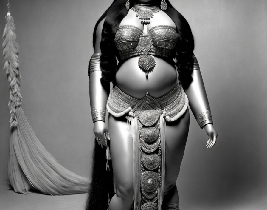 Monochrome image of curvaceous figure in ornate belly dancer costume