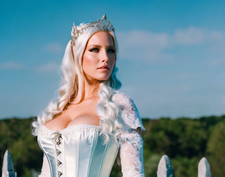 Blonde Woman in Crown and Medieval Dress Against Blue Sky