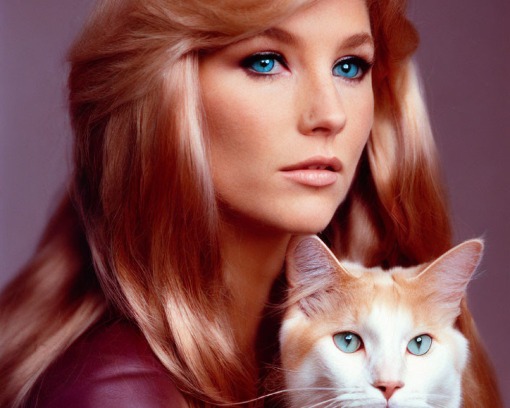 Blonde woman with blue eyes poses with orange and white cat