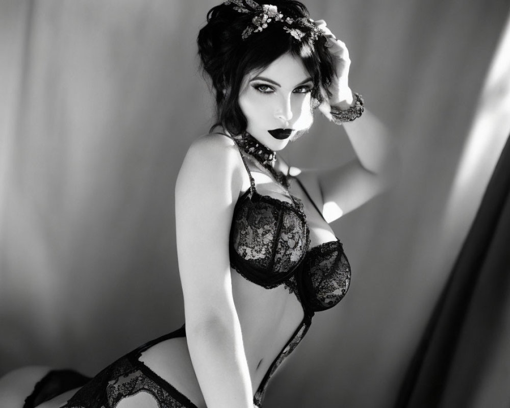 Monochrome photo of woman in lingerie with floral headpiece posing seductively