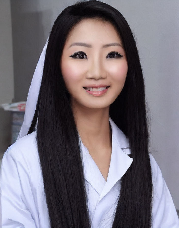 Smiling woman with long black hair in white hooded jacket