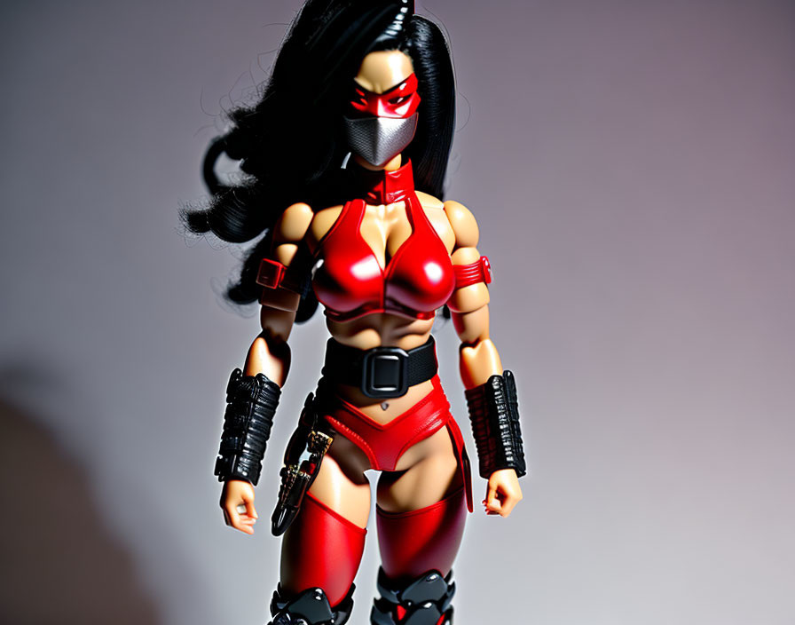 Female character action figure in red and black costume with mask and utility belts