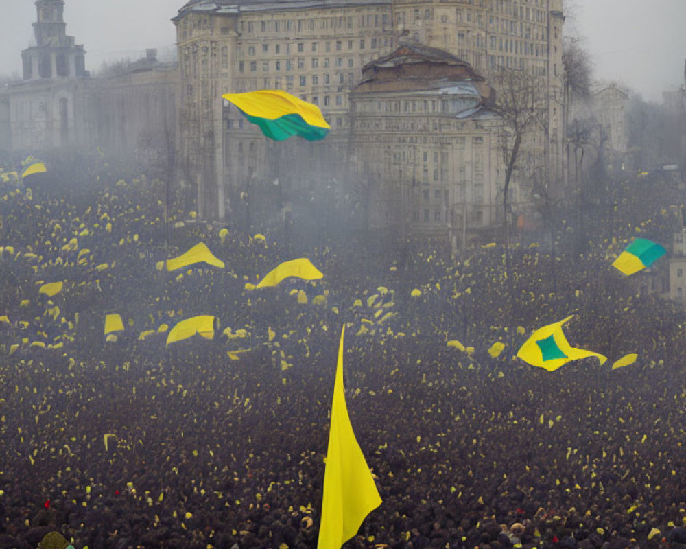 Crowd with yellow flags in foggy city square demonstration.