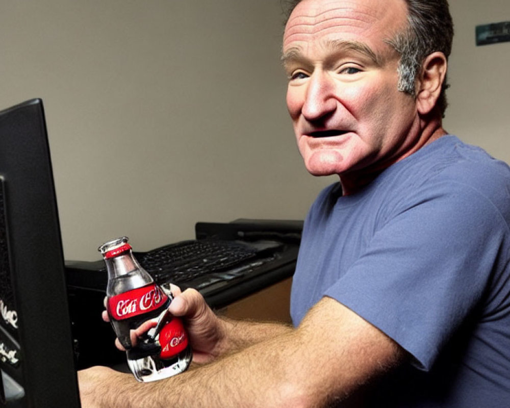 Person at Desk Smiling with Coca-Cola Bottle