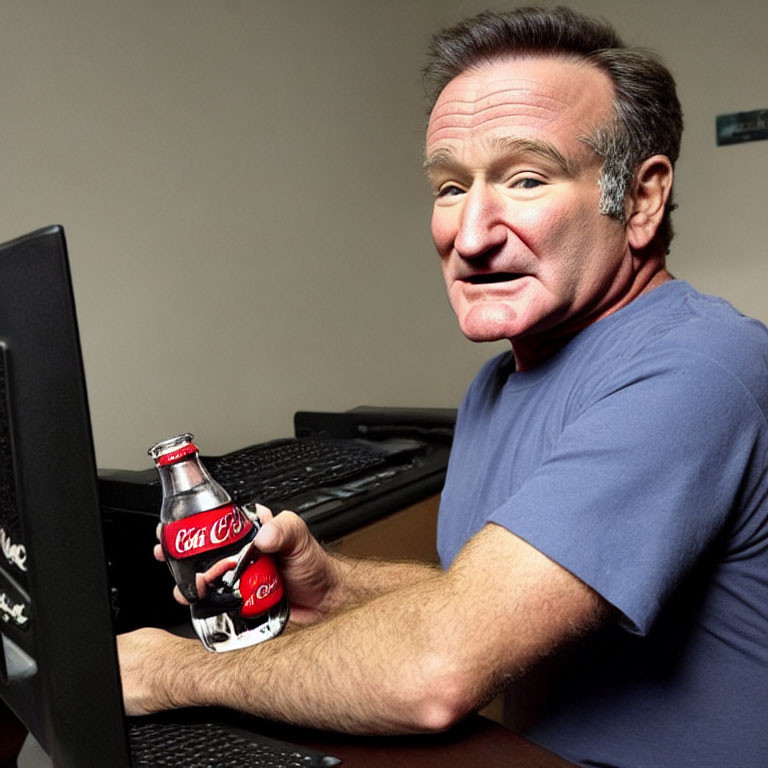 Person at Desk Smiling with Coca-Cola Bottle