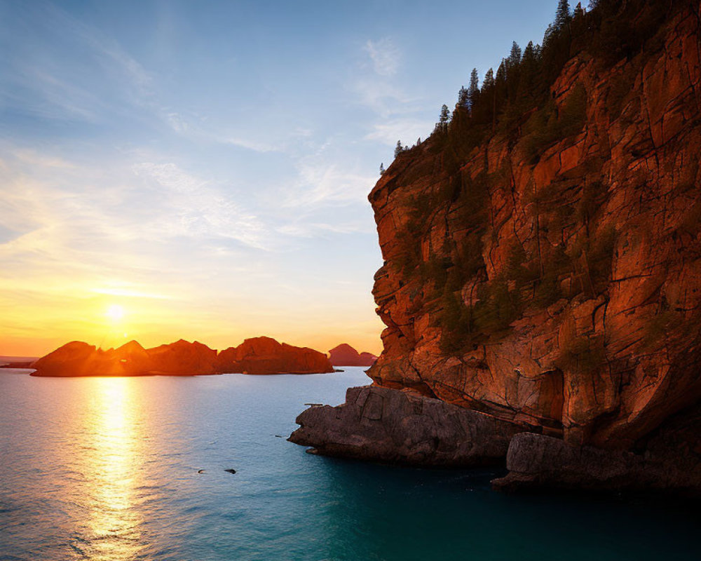 Tranquil sunset scene with golden light on rugged cliff and silhouetted islands