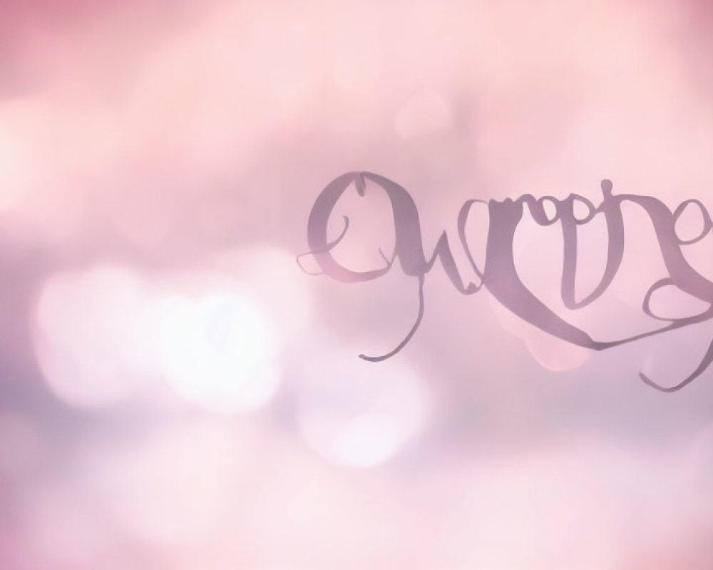 Elegant script on soft pink bokeh background