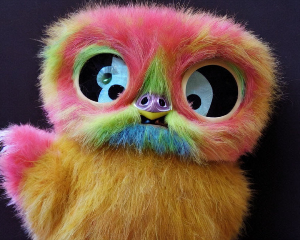 Colorful Plush Toy with Large Expressive Eyes in Pink, Yellow, and Green Tones