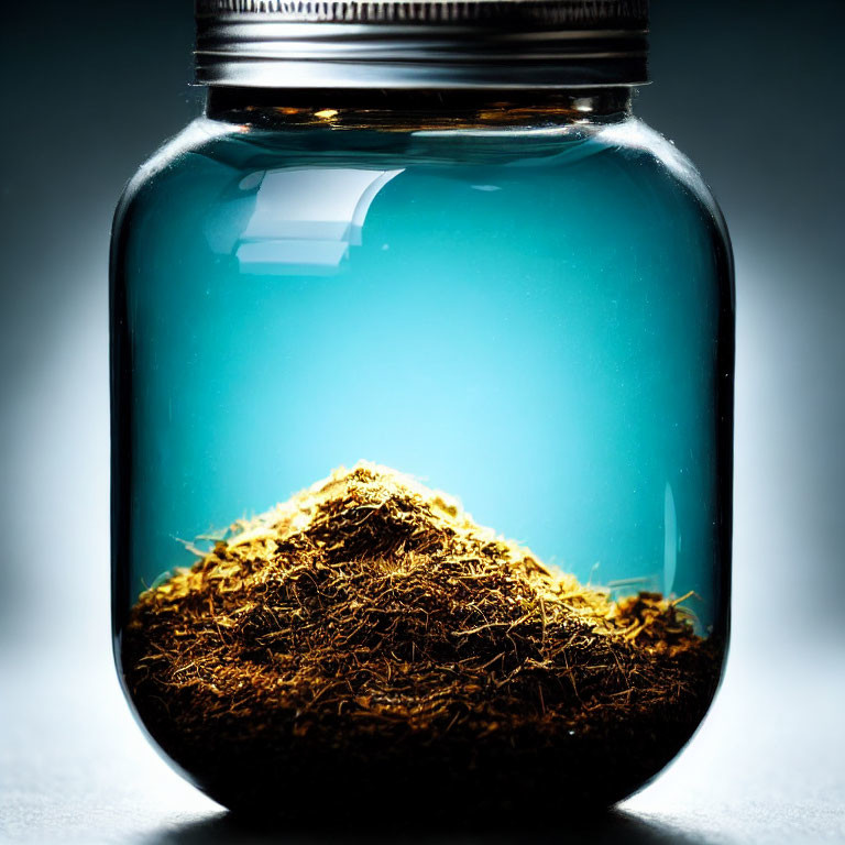 Glass Jar Filled with Tobacco Leaves on Soft Blue Background