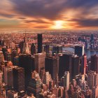 Surrealist cityscape merging with ocean at sunset