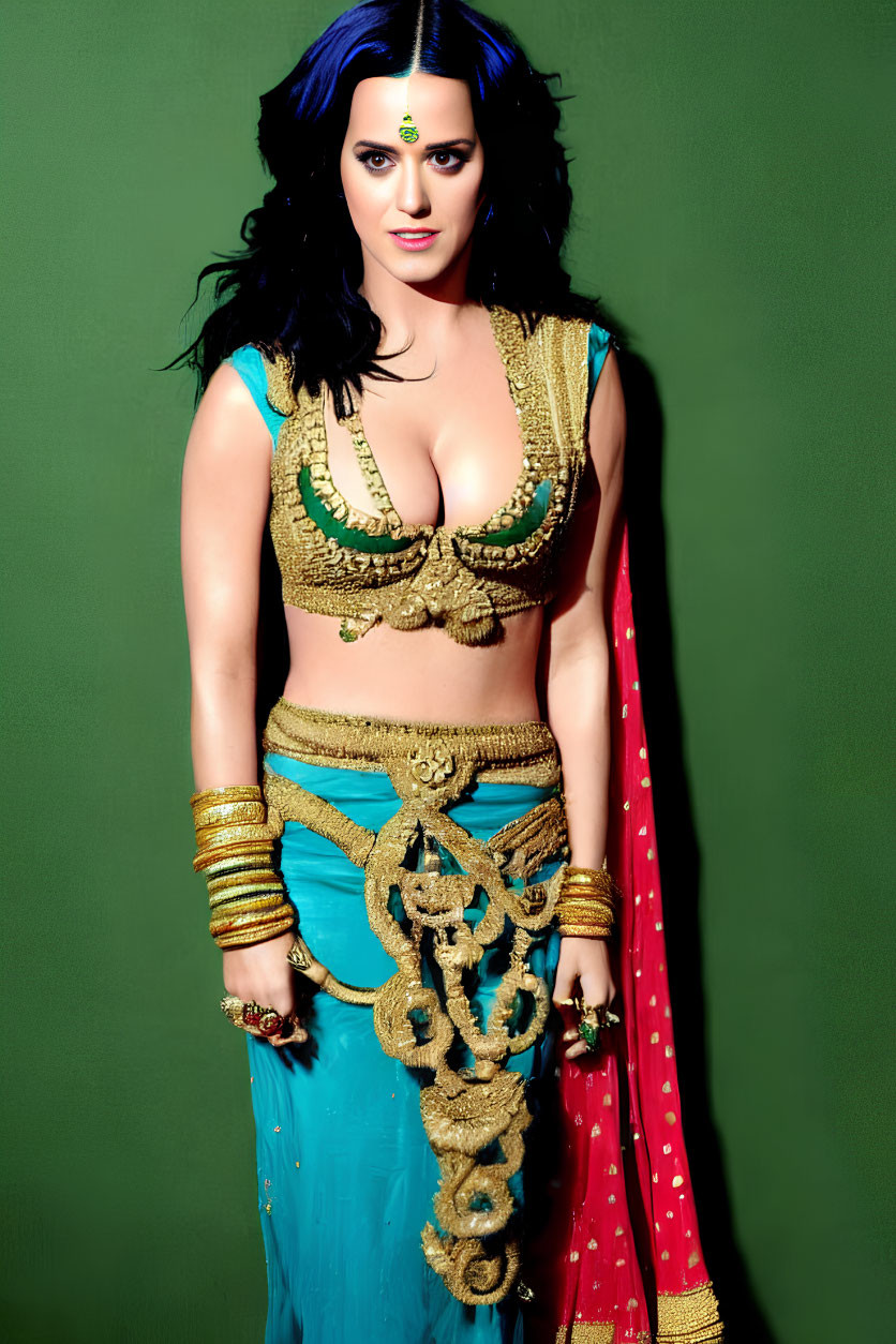 Traditional Indian Woman in Ornate Attire Against Green Background