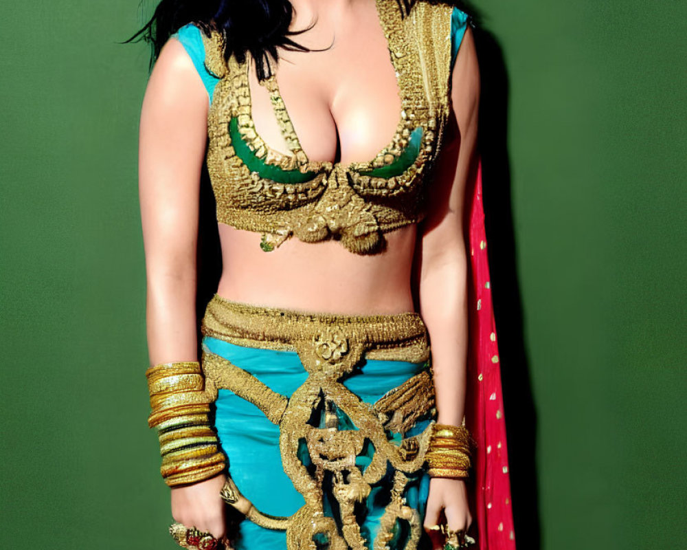 Traditional Indian Woman in Ornate Attire Against Green Background