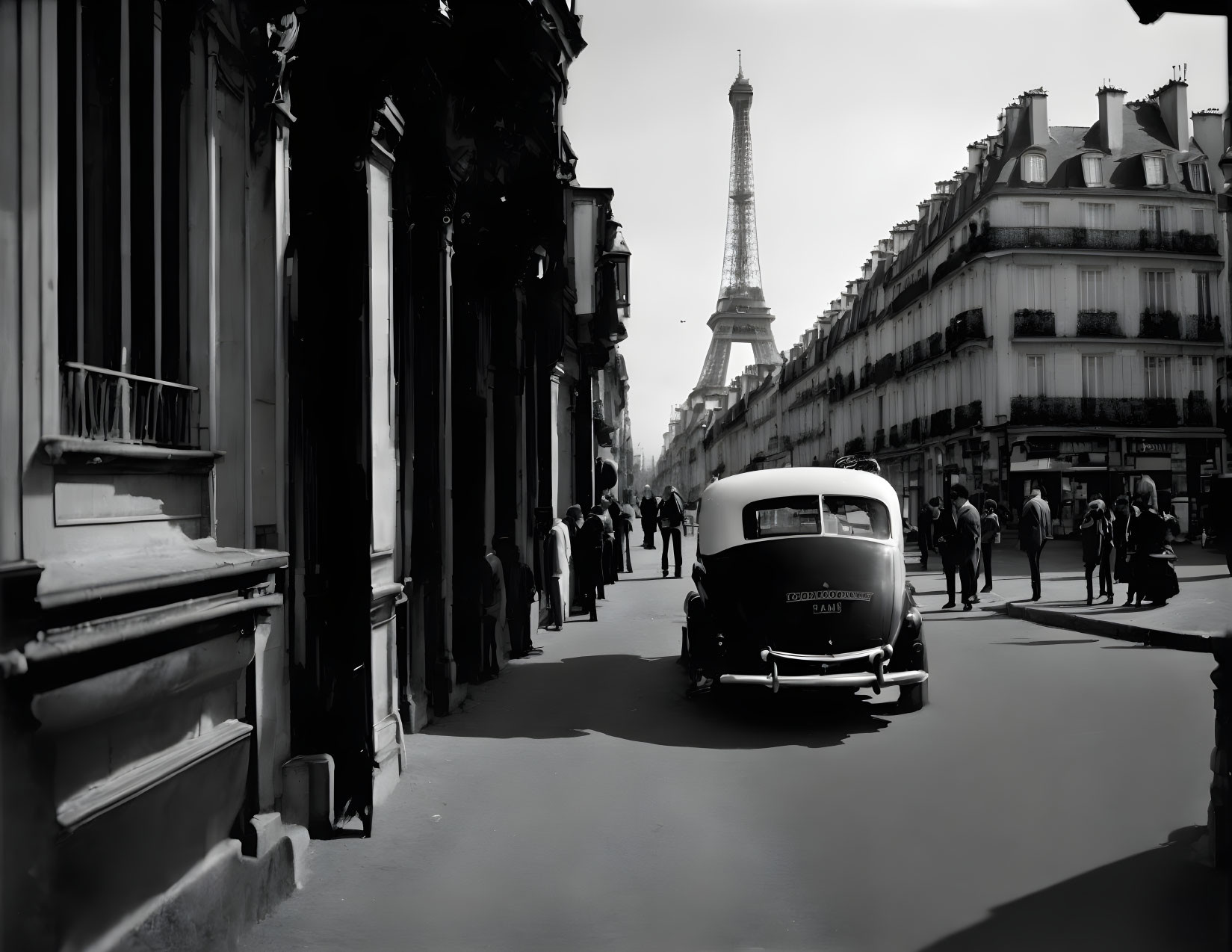 Vintage car on Paris street with Eiffel Tower in background