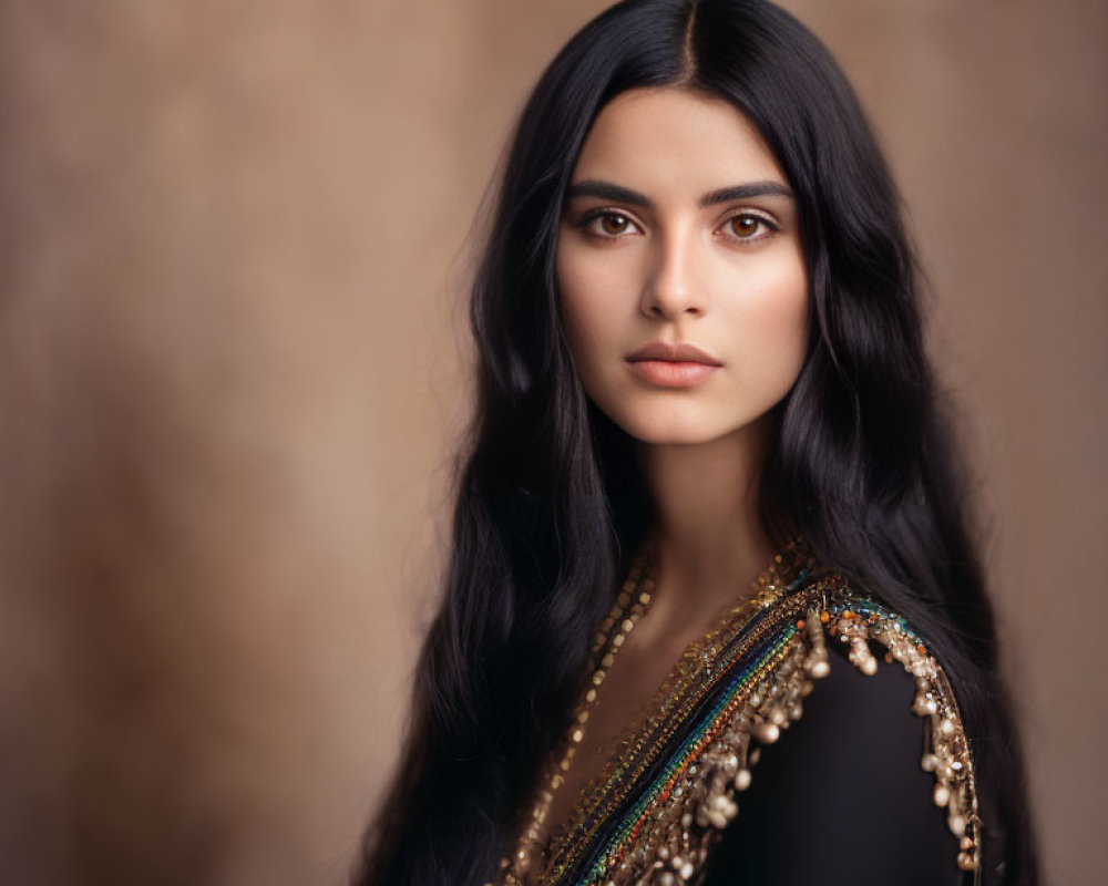 Woman with Long Black Hair in Decorative Black Outfit on Blurred Brown Background