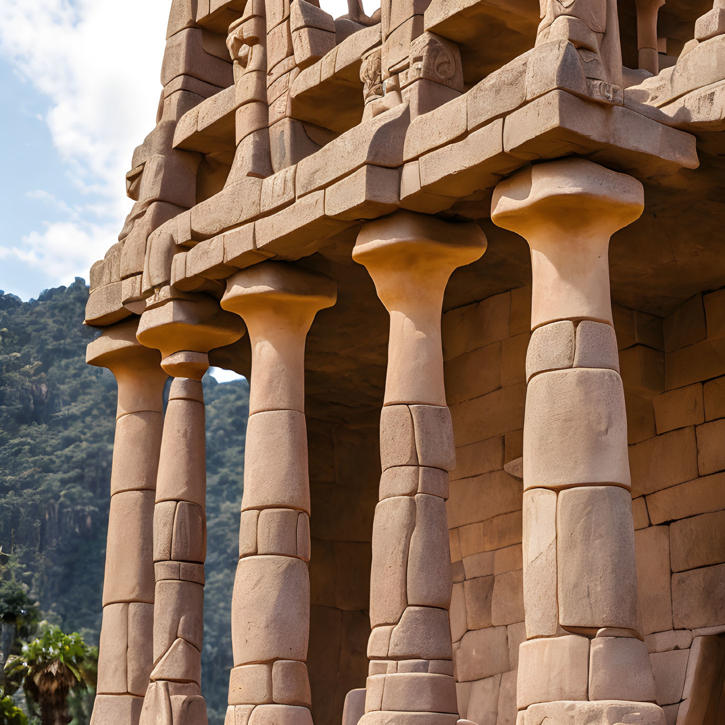 Ancient-style stone columns with intricate carvings in natural setting