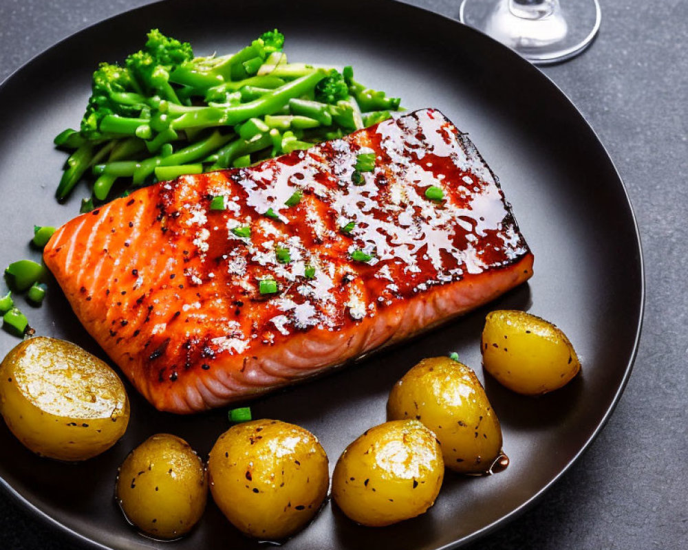 Grilled Salmon with Glaze, Green Beans, and Roasted Potatoes on Dark Plate