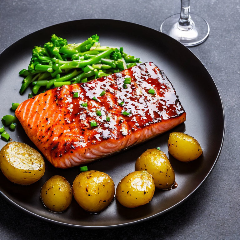 Grilled Salmon with Glaze, Green Beans, and Roasted Potatoes on Dark Plate