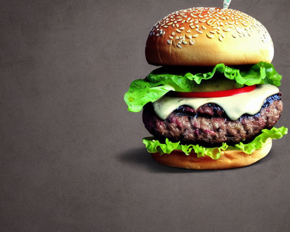 Classic Cheeseburger with Lettuce, Cheese, Tomato on Sesame Seed Bun on Dark Background