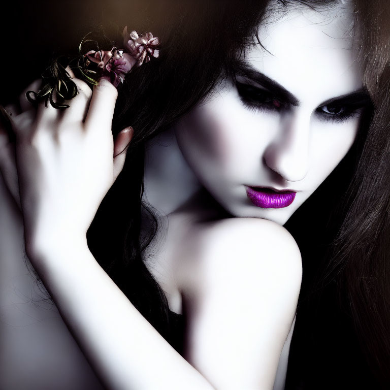 Dark-haired woman with purple lipstick holding flowers for a dramatic look