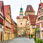 Vibrant painting of medieval village street scene