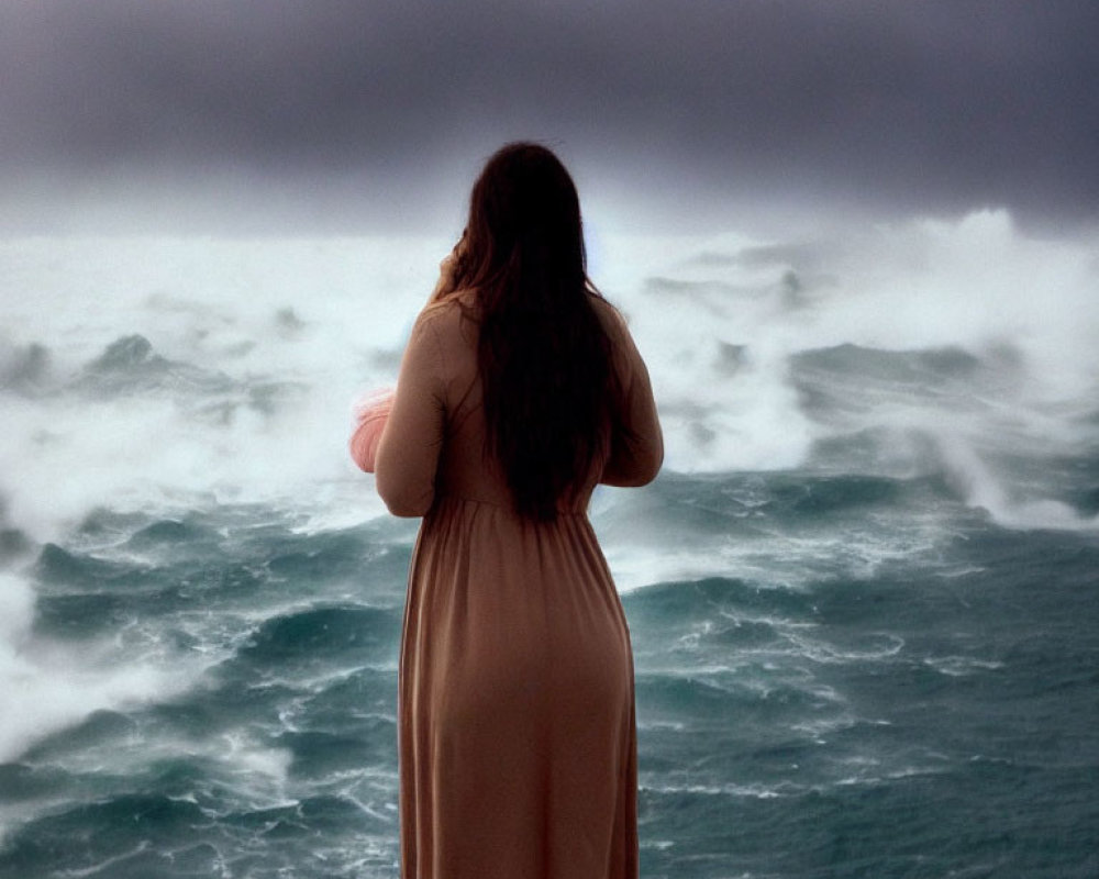 Woman in Beige Dress on Cliff Overlooking Stormy Sea