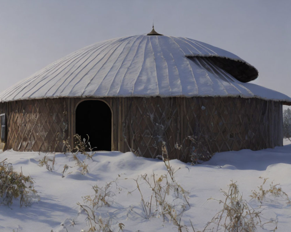 Round wooden yurt with snow-covered conical roof in snowy landscape