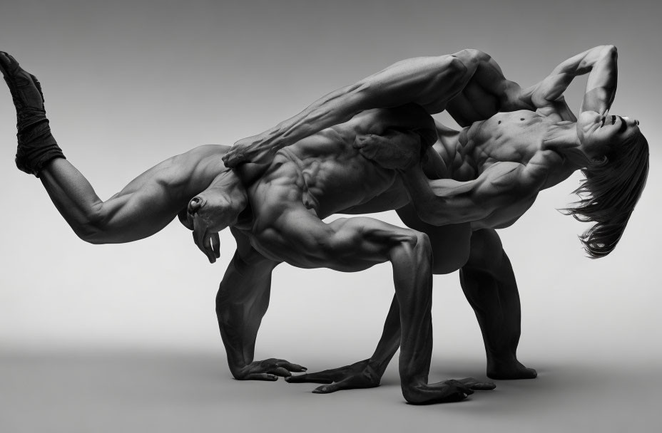 Muscular individuals in challenging artistic pose