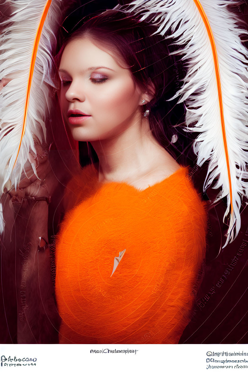 Ethereal woman in orange with white feathery wings on wooden background