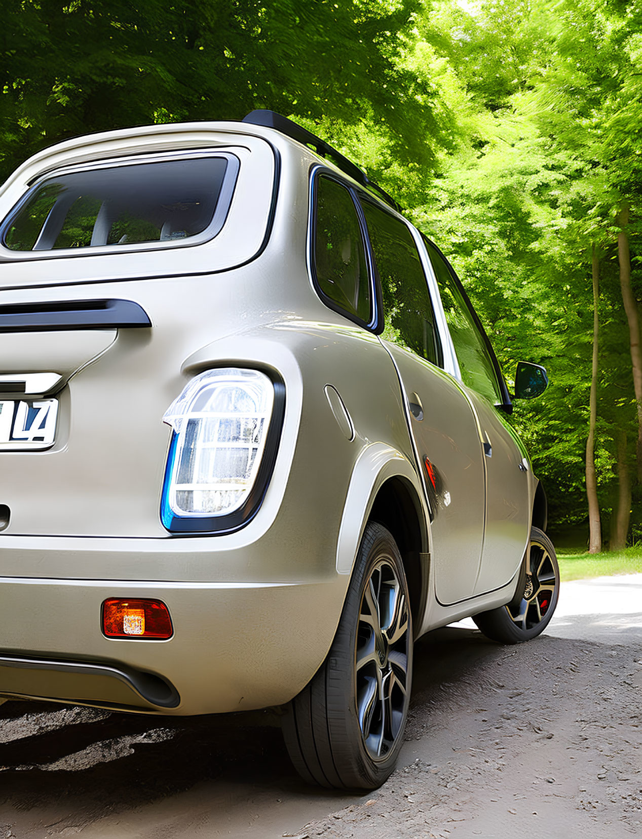 Beige hatchback car parked on road with lush green trees, highlighting rear and side profile.