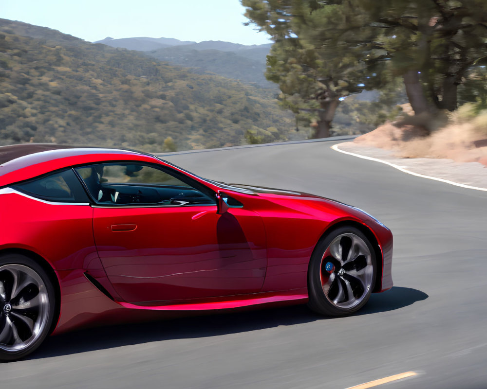 Red sports car on road under clear blue skies with lush greenery