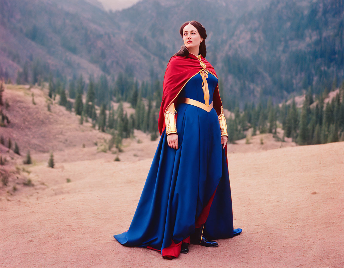 Female superhero in red and blue costume on mountain landscape