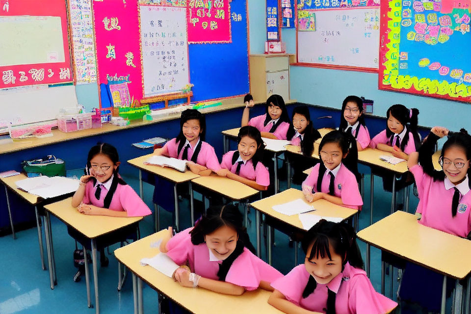 Smiling students in pink uniforms in a classroom with educational posters