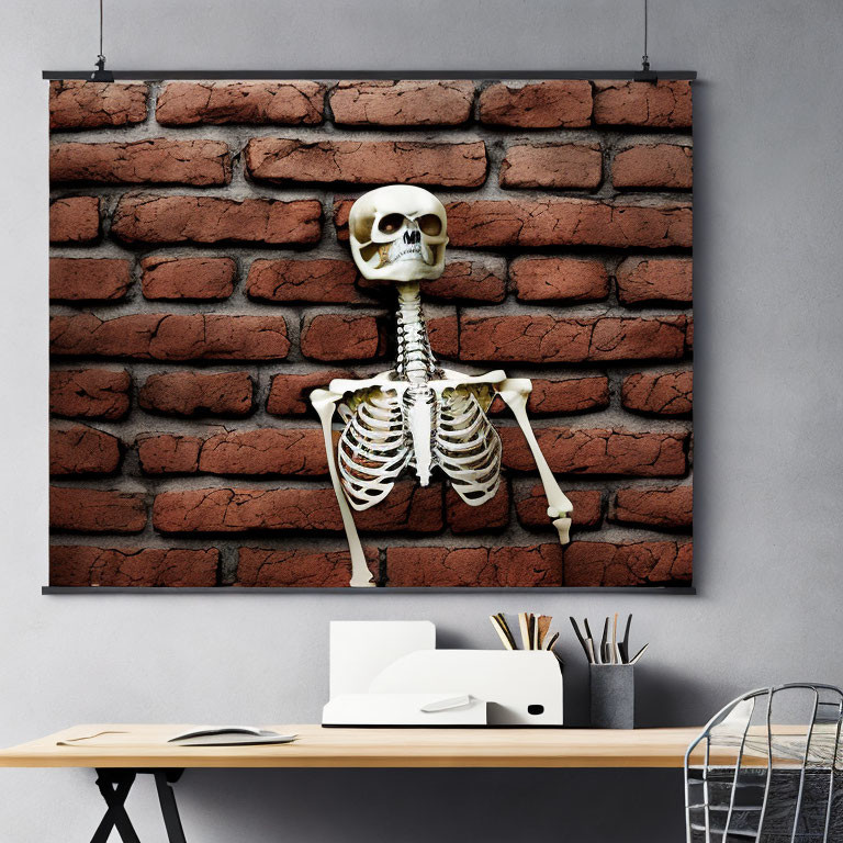 Human skeleton poster displayed in modern workspace with computer and office supplies