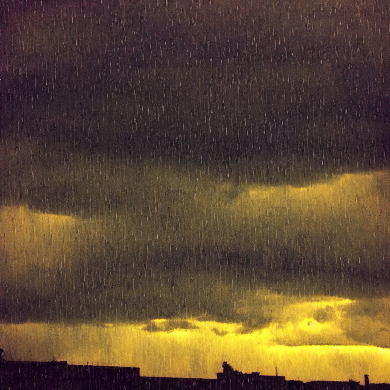 Dark storm clouds over city lights in heavy rain