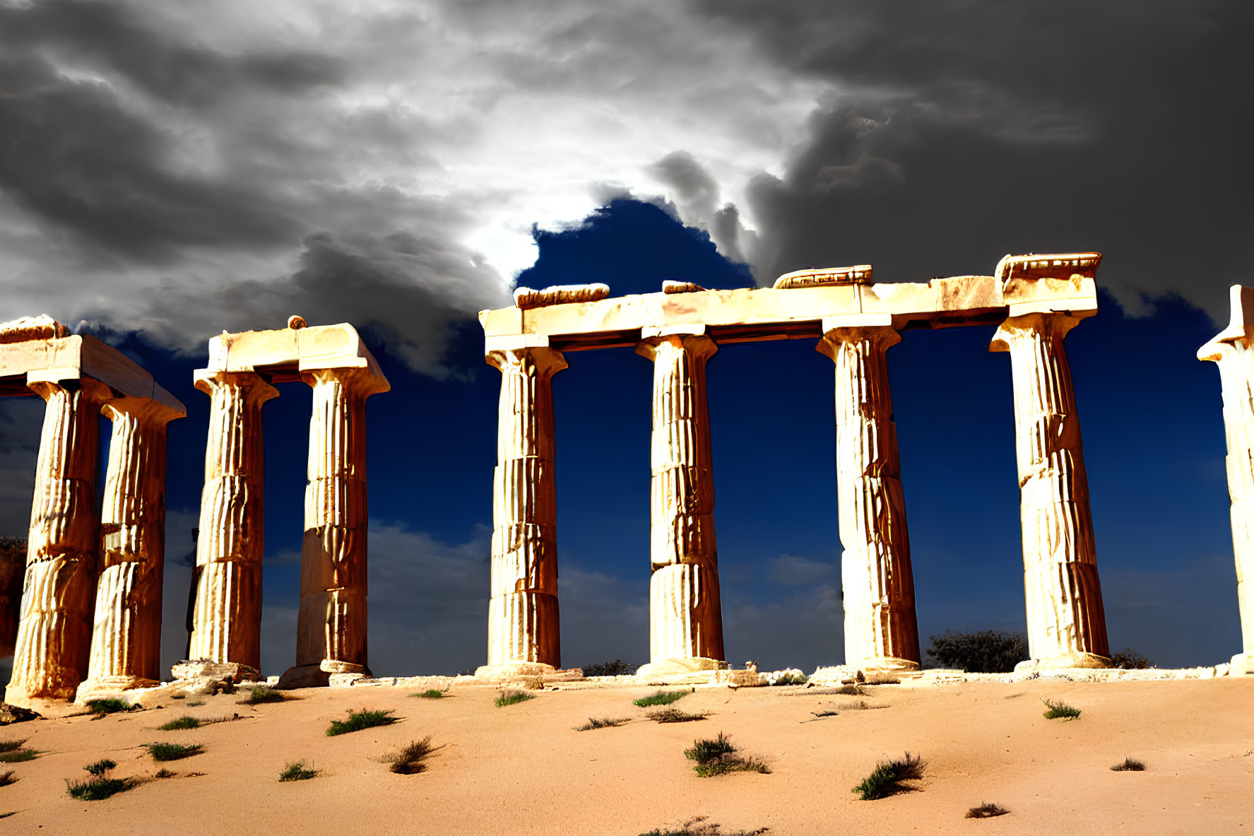 Ancient column ruins under dramatic sky in desert landscape